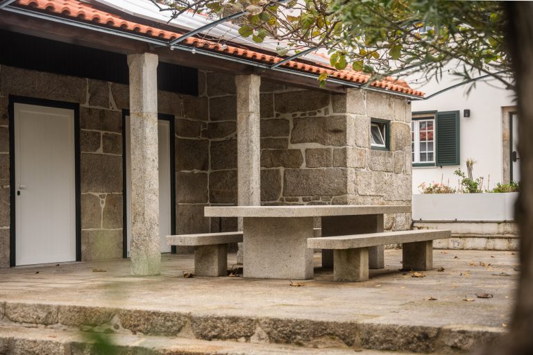 Granite table and benches under a tiled roof