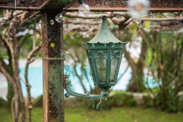 Old lantern under the pergola by the pool