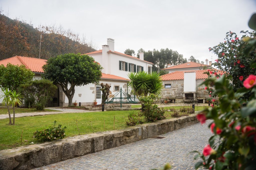 White houses with red roofs and gardens