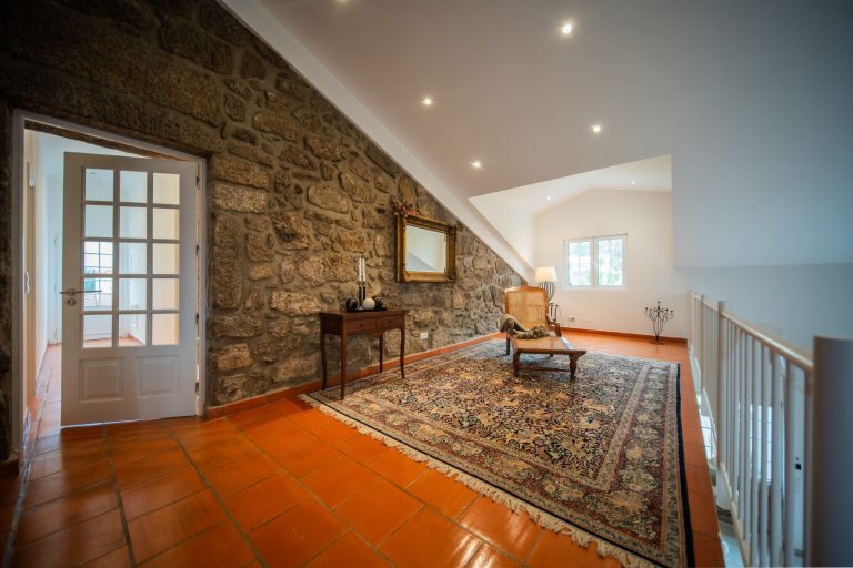 Casa 8: armchair by the stone wall