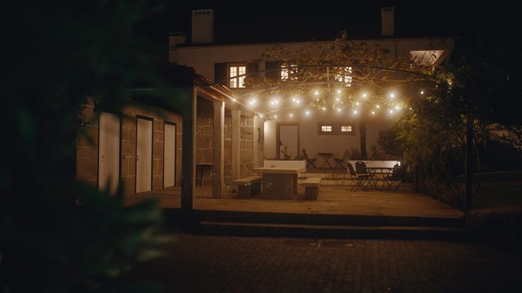 Covered terrace with string lights in the evening